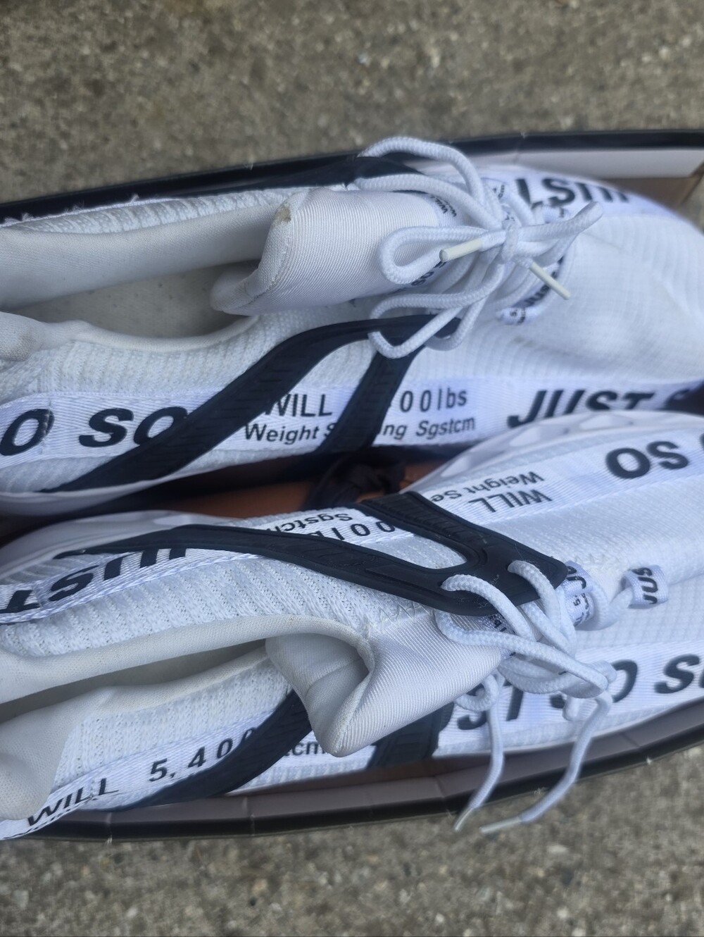 White Athletic Sneakers with Black Accents - Text Detail